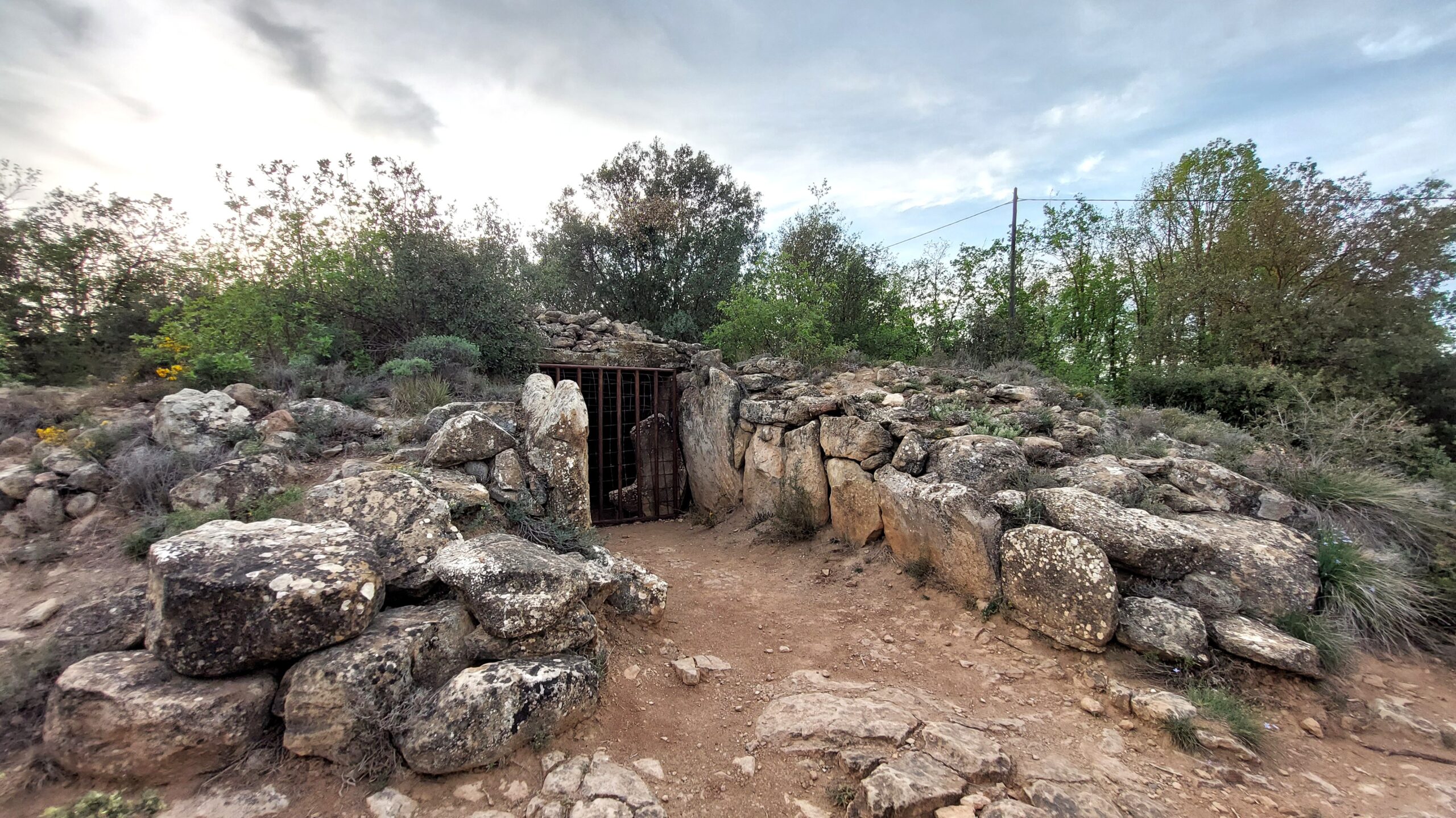 The Dolmen de Llanera, Lleida, Spain is still partially covered by its tumulus.